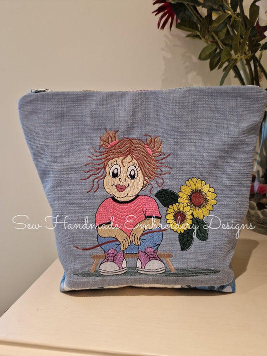 Pretty little girl & sunflower embroidery pattern stitched onto a demin zipper bag 